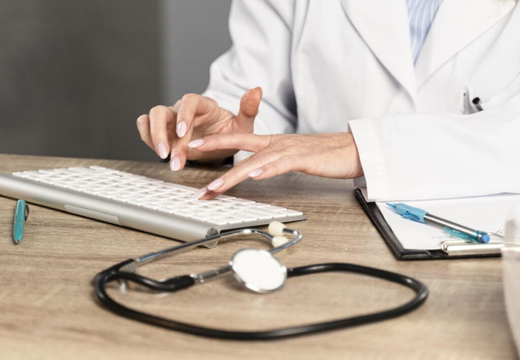 female physician her desk writing keyboard